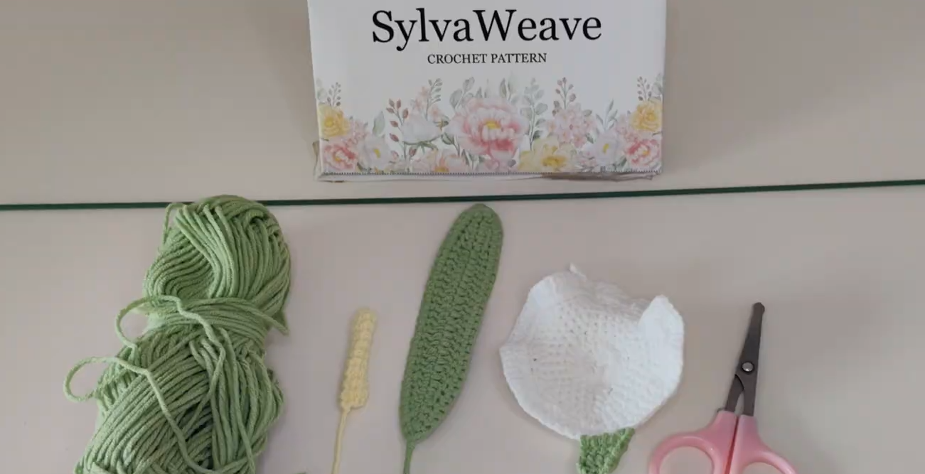 Crocheted calla lily parts and tools ready for assembly