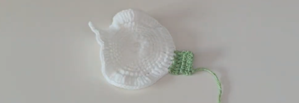 Green flower base attached to the white calla lily petal