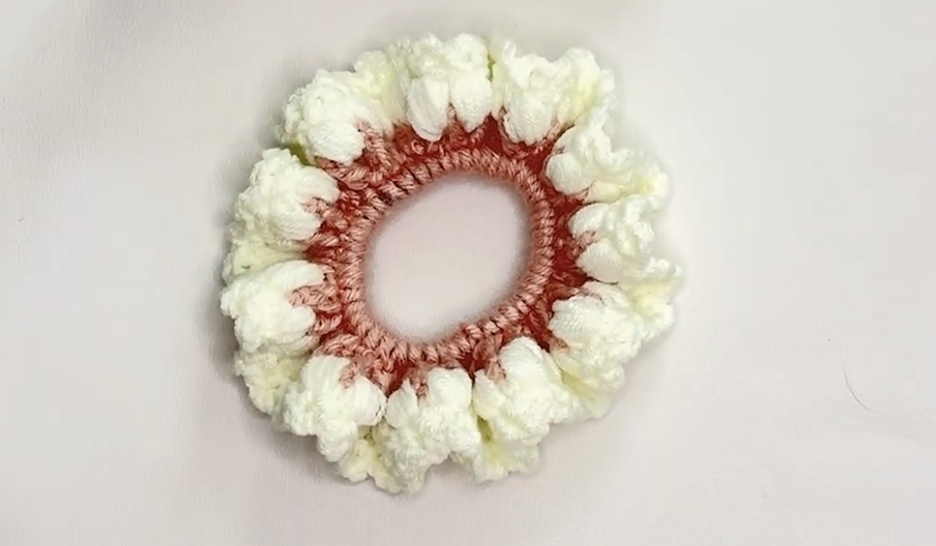 Completed pink and white crochet flower scrunchie