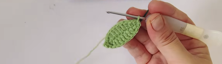 Green crochet hibiscus leaf with a shaped tip and wire support
