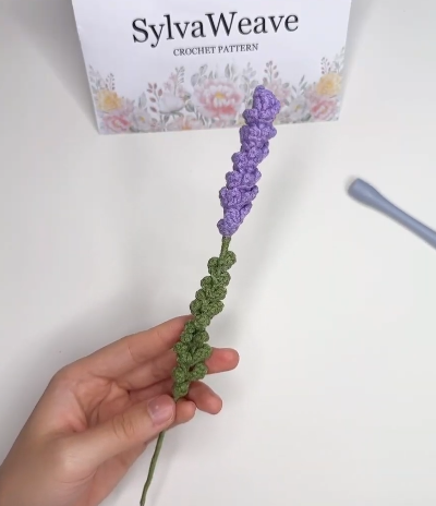 Finished purple crochet lavender flower with green leafy stem