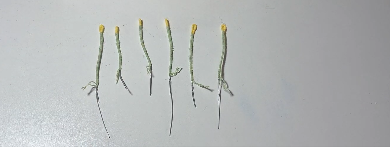 Six handmade yellow and green stamens for a crochet flower