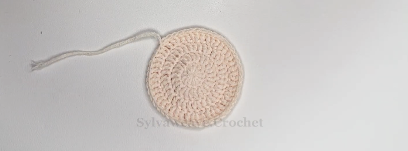 Completed cream circular base for the crochet tulip coaster